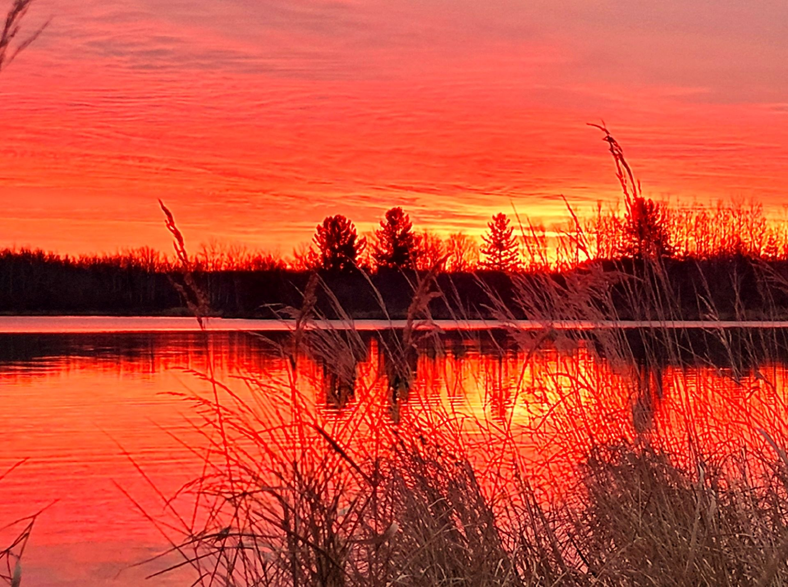 Beautiful sunset over Deer Lake at Deer Lake Farmstead RV Park, Malmo, MN